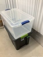 Stacked clear and gray Sterilite storage bins showing shape and lid fit