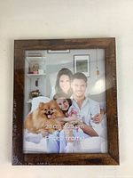 Wood picture frame showing packaging and 8x10 inch photo size mark.