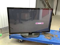 Front view of LG 42-inch plasma TV on blue cart showing screen with 'No Signal' message and black stand.