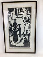 Black and white signed print depicting a street scene with four figures in Orthodox religious attire, framed with white mat and simple frame.