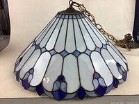 Full view of stained glass shade, chain, canopy, mounting hardware