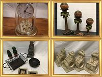 Photo showing the glass dome anniversary clock, metal turtle candle holders with palm tree bases, carved architectural style decorative pieces, and various small decorative and framed items.