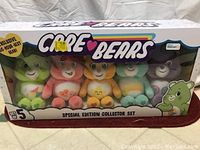Photo of a boxed set of five colorful Care Bears plush toys in original packaging labeled as 'Special Edition Collector Set'.