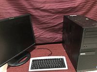 Full view of Dell desktop tower, Planar monitor, and keyboard arranged together for display.