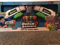 Photo of boxed Zuru Bunch O Balloons kit containing two X-Shot balloon launchers and 100 self-sealing water balloons.