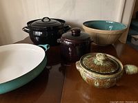 All four items: two ceramic casseroles with lids, enamel casserole dish, and ceramic mixing bowl.