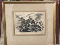 Framed sketch art of castle atop rocky hill with cloudy sky, signed by St. Miachel.
