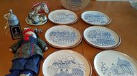 Overview photo showing six blue and white plates, doll, and shaker set with an additional ceramic item