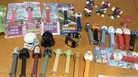 Overview photo showing multiple Star Wars Pez dispensers, ceramic salt and pepper shakers, Star Wars watch, and Cali Raisins Pez dispensers.