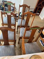 Overview of all six chairs arranged in two rows showing wood finish and upholstery