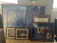 Overview of all six framed artworks grouped together, showing variety in size and framing styles.