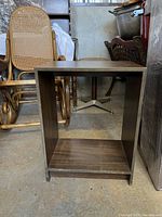 Photo of particleboard open cabinet with dark wood finish, scratches visible