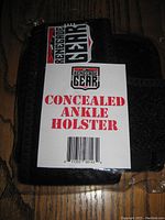 Front of the sealed black nylon concealed ankle holster with Renegade Gear label and barcode tag attached.
