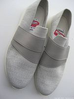 Front and top view of light grey Vince slip-on shoes showing the knit fabric and elastic band across the top.