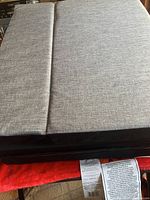 Fold-up mattress partially folded showing fabric texture and thickness