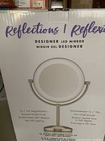 Box image showing product branding and illustration of the mirror with double-sided feature and magnification levels.