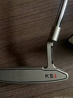 Close-up of the metallic silver putter head showing milled face, TruLine branding, and KS1 marking.