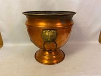 Full view of copper vase with wide bowl and pedestal base