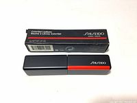 Photo showing new in box Shiseido Color Gel Lip Balm with original packaging, black box with red and white text.