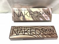 Front view of the new in box Urban Decay Naked Skin Shape Shifter palette with exterior packaging and the closed palette showing rose gold metallic design.