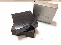 Laura Mercier Face Illuminator with outer silver box and black compact case.