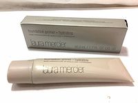 Photo of Laura Mercier Foundation Primer Hydrating tube and its box showing product name and size 50 ml / 1.7 fl oz