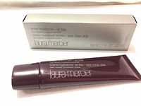 Photo of the Laura Mercier tinted moisturizer tube and its box showing product name, size, and oil free description