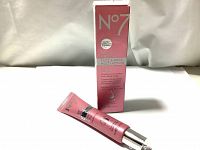 Photo of the pink No7 serum tube beside its retail box showing front product branding and size.