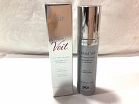 Front view of Pur Liquid Veil spray foundation bottle with its box, showing the product name and key features on packaging.