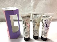 Three VitaBath body cream tubes with visible labels: Pomegranate Bellini Blush, Heavenly Coconut Creme, Lavender Chamomile. Packaged together with a purple-pink cardboard box.