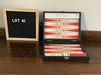 Photo showing backgammon set open with visible playing surface and a small sign indicating Lot 41.