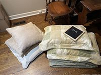 Comforter and pillows arranged on floor showing leaf pattern and colors