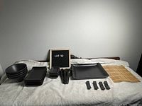 Full set displayed including bowls, plates, spoons, chopstick holders, and sushi mat.