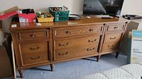Full view of 9-drawer Haddon Hall dresser showing all drawers and wood finish.
