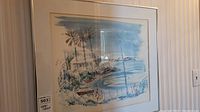 Framed watercolour artwork mounted on a wall, showing entire visible area of the painting, depicting a coastal scene with palm trees and shoreline, signed Birdsey.