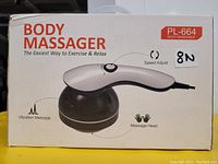 Front view of the box showing the PL-664 body massager with speed adjust dial, vibration massage feature, and massage head.