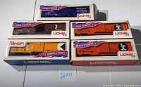 Five Lionel boxcars in original boxes showing shelf wear and boxes' front-displays.