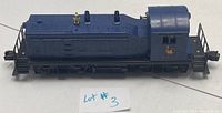 Side view of Lionel 621 Jersey Central Lines diesel locomotive model showing blue paint, brass bell, detailed roof and side vents, including visible Jersey Central Lines logo and couplers front and back.