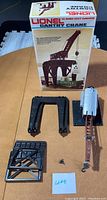 Complete lot layout of gantry crane parts with box on brown surface