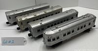Four Lionel Lines silver metal passenger train cars with black lettering; models numbered 2423 Hillside, 2429 Livingston, 2434 Newark, 2422 Chatham, showing general worn condition.