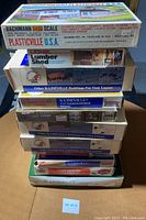 Stack of various Plasticville, K-Line, Lionel model building kits in original boxes