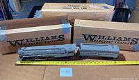 Side view of engine and tender with original Williams Electric Trains boxes and measuring tape.