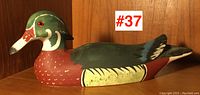 Side view of the wooden duck decoy showing detailed paint work and full length profile.