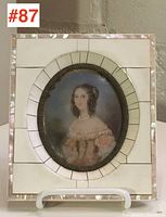 Full view of the rectangular piano key frame with the oval portrait miniature of a woman inside, showing overall condition including minor warping of frame piano keys.