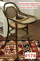 Front angle showing tray, cane seat and curved backrest