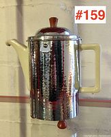 Front view of coffee pot showing spout, handle and overall body