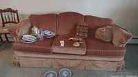 View of the full Flexsteel fabric upholstered sofa with various items on and around it.