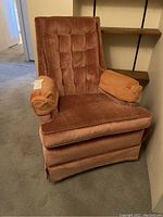 Front angled view of the vintage velvet rocker chair with tufted high back and arm covers.