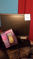 Dell flat screen monitor with Dell black keyboard and Kensington Mouse 2000 box