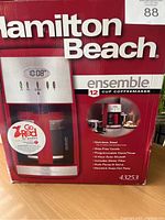 Front side of the Hamilton Beach coffee maker box showing product image, brand, and key features.